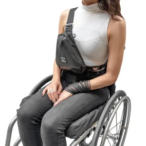 Image of the Handy Hybrid Bag on a woman in wheelchair - Versatile wheelchair bag designed for easy attachment and storage of essential items, featuring multiple compartments and a comfortable carry handle.