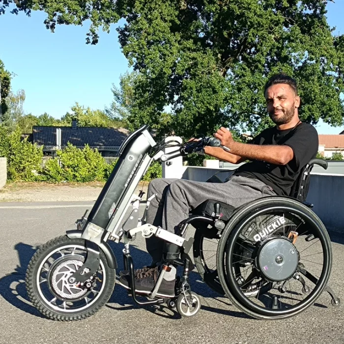 Side view image of a man enjoying his Sirocco 2.0 Adventurer Power Assist - Compact, maneuverable wheelchair designed for outdoor adventures.